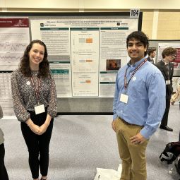 two students in front of their presentation at DUSC