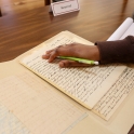 close up of a hand resting on a historic document