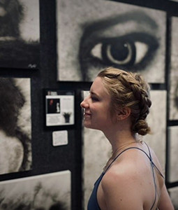 a women looks at black and white artwork