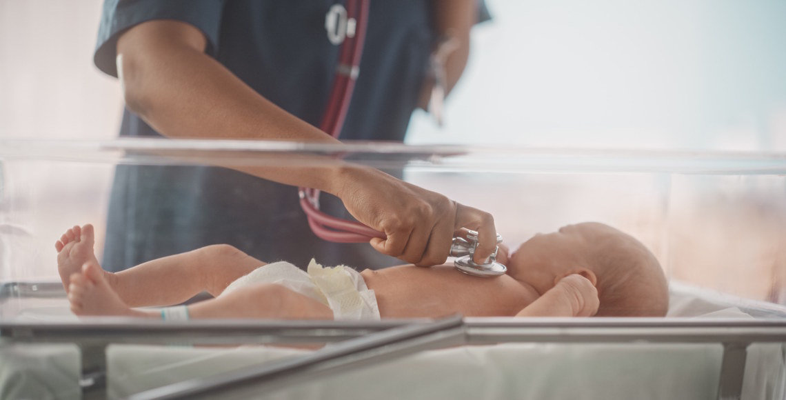 clinician examining newborn