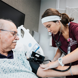 USC Nursing student takes a patient's blood pressure during a clinical simulation